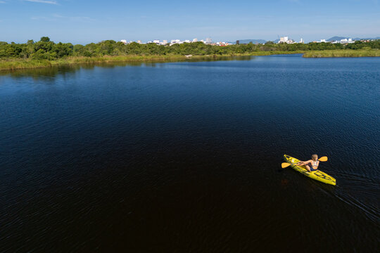 Happy active kids have a fun on yellow kayak in sea lagoon.  Healthy lifestyle. Recreational water sport, kayaking tour in adventure camp on family summer beach vacation
