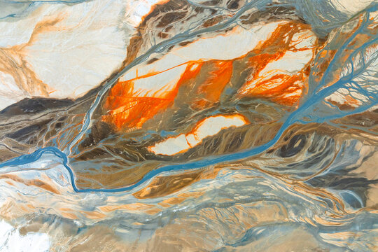 Abstract landscape of vibrant streams and erosion patterns