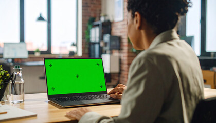 Creative Home Office Scene with Woman Using Laptop, Green Screen Ready for Replacement

