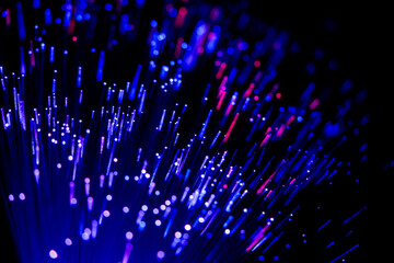Glowing fiber optic cables in abstract colors