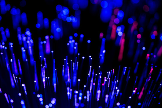 Optical fiber glowing with blue and purple lights - Powered by Adobe