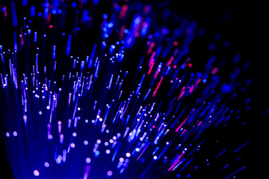 Glowing fiber optic cables in abstract colors