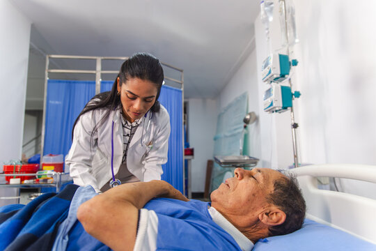 Doctor attending a patient in a hospital room