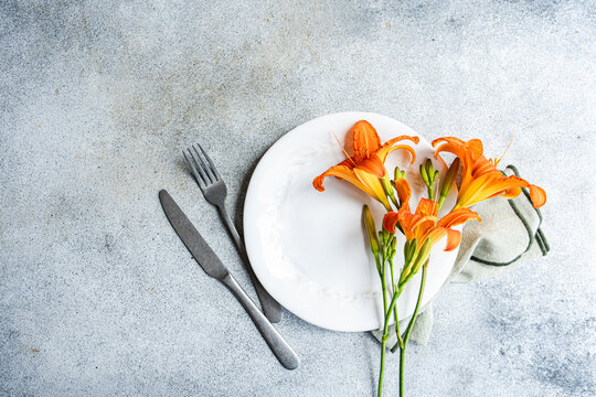 Tiger lily set on a white plate in elegant dining arrangement