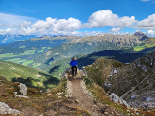 Rear view of Asian Man looking at the scenery in Seceda Mountain in Val Gardena, Bolzano, South...