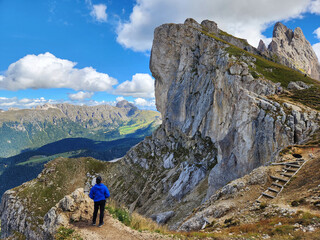 Rear view of Asian Man looking at the scenery in Seceda Mountain in Val Gardena, Bolzano, South...