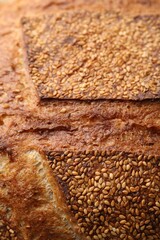 Tasty fresh bread with sesame seeds as background, closeup