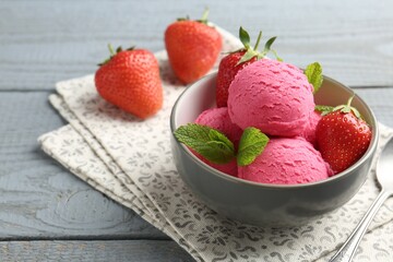 Tasty sorbet with strawberries and mint served on grey wooden table, closeup