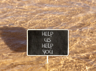 Naklejka premium Help you symbol. Concept words phrase Help us help you on beautiful black blackboard. Beautiful Red sea water background. Business Help you concept. Copy space.
