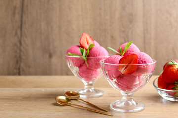 Refreshing sorbet, strawberries, mint and spoons on wooden table, closeup. Space for text