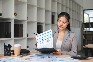 Businesswoman searching for documents in a file in an office