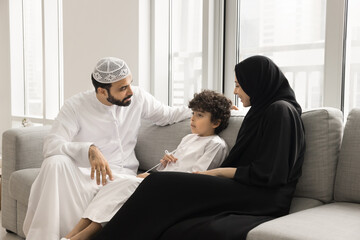 Open communication in parental guidance. Caring young Arabic family couple in traditional Muslim...