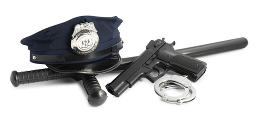 Police cap, gun, handcuffs and baton on white background