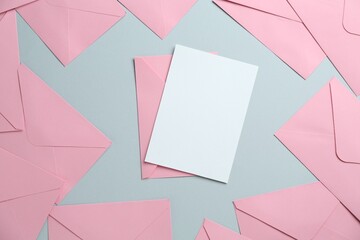 Blank invitation card and envelopes on grey background, flat lay. Space for design