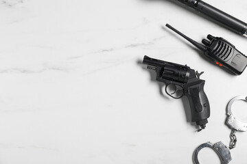 Different police equipment on white marble table, flat lay. Space for text