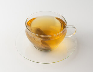 Herbal tea sachet in cup, hot water with chamomile and Hypericum or St. John's wort teabag
