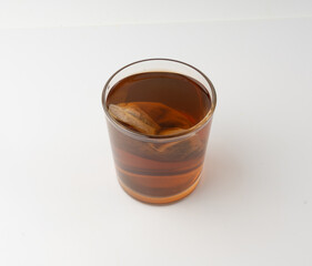 Herbal tea sachet in glass, hot water with chamomile and Hypericum or St. John's wort teabag