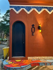 Restroom with Colorful Decor: A charming restroom exterior features a vibrant mosaic and intricate design with an inviting ambiance, perfect for outdoor settings.