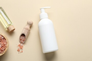 Flat lay composition with bottle of liquid soap, sea salt and essential oil on beige background....