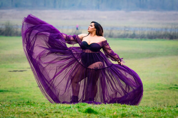Flowing dress in the wind in a meadow