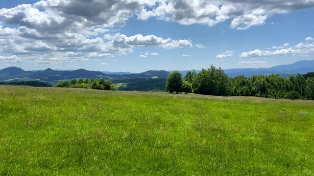 Polish meadow, mountain landscape in the background. Peace and quiet of nature.