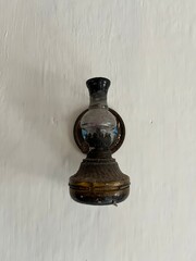 Antique brass jug and king chess piece on a wooden table, isolated on white, evoke an old-world strategy game