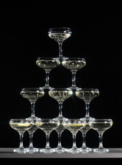 champagne glass tower on black background
