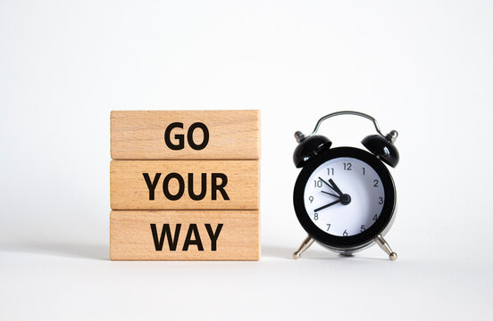 Go Your Way symbol. Wooden blocks with words Go Your Way. Beautiful white background with alarm clock. Business and Go Your Way concept. Copy space.
