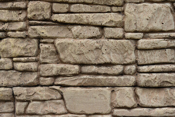 Decorative stone wall forming a seamless texture, ideal for backgrounds and design projects, showing the craftsmanship and natural beauty of stonework