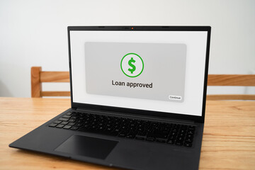 Loan approved notification on laptop screen. Concept of online banking process.
