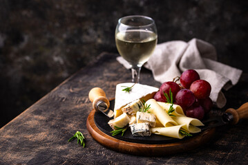 Different types of cheese, wine and grapes