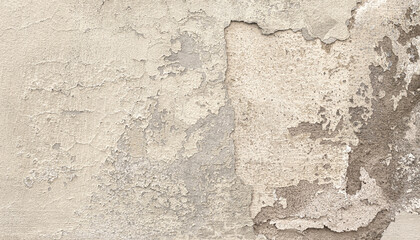 Old damaged plaster wall with flaking paint showing concrete underneath