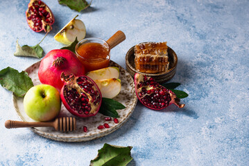 Rosh Hashana concept with honey, apple and pomegranate