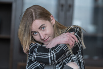 Stylish Woman Smiling with Confidence in Trendy Checkered Shirt