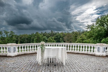 Outdoor Wedding Table Decorated with Flowers Under a Dramatic Cloudy Sky