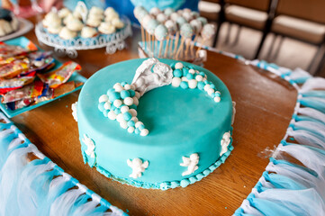 Blue-Themed Baptism Cake with Angel Decorations and Pastel Accents