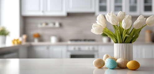 A modern kitchen with white cabinets and walls, featuring tulips in pastel colors placed on the countertop near Easter eggs, creating an atmosphere of springtime celebration