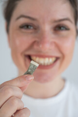Woman Chewing Nicotine Snus Product. 