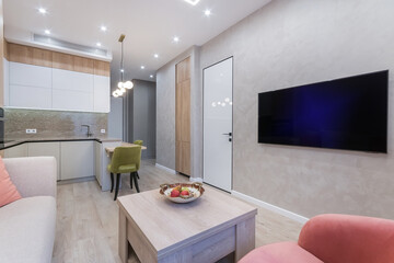 This cozy living space showcases a minimalist design with a light color palette. A comfortable...