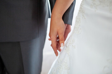 Bride and groom holding hands during wedding