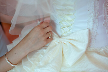 Bride Adjusting Wedding Dress Detail