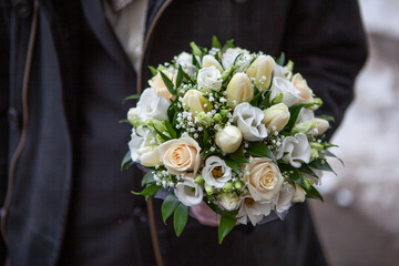 Person holding elegant wedding bouquet