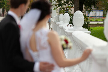 Bride and Groom by White Bridge Railing