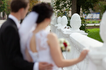 Bride And Groom By White Fence