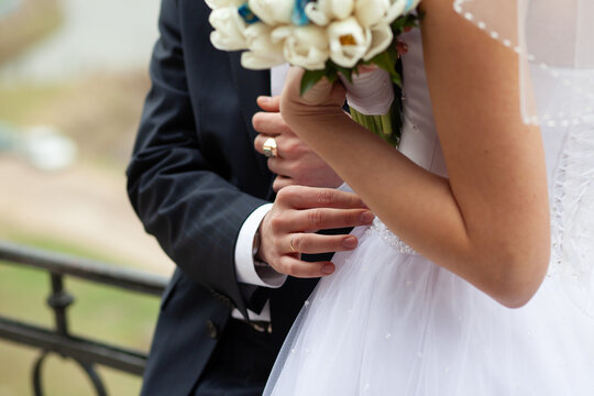 Bride and groom holding hands at wedding ceremony - Powered by Adobe