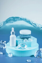 Skincare serum essence glass bottle on ice blue background. Concept summertime beauty product....