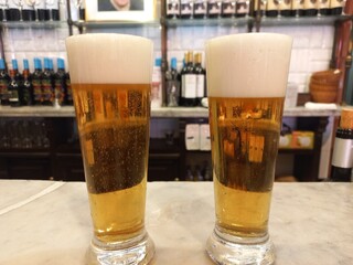 Refreshing beer glasses on a bar counter in a cozy pub setting. World Beer Day