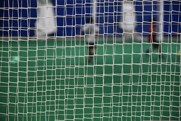 Behind the net of a football goal