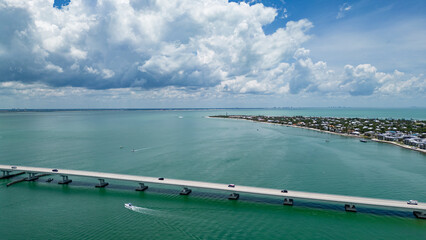 Aerial view of sanibel island causeway with light house in distance on clear summer day with fluffy...