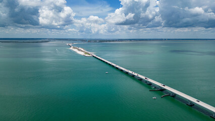 Aerial view of sanibel island causeway with fort myers in distance. 